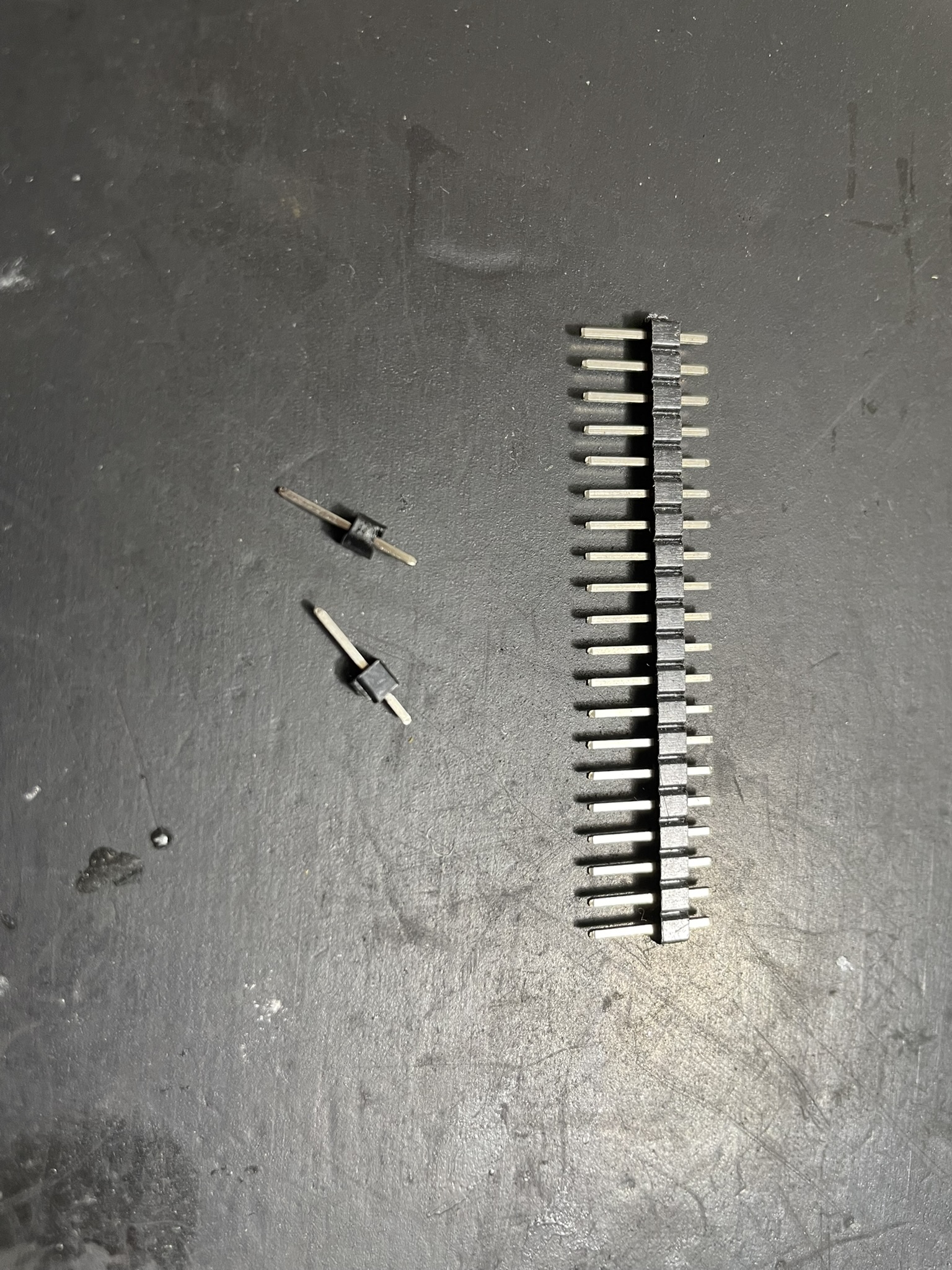 A workbench with various electronic components and tools, including resistors, connectors, and capacitors.