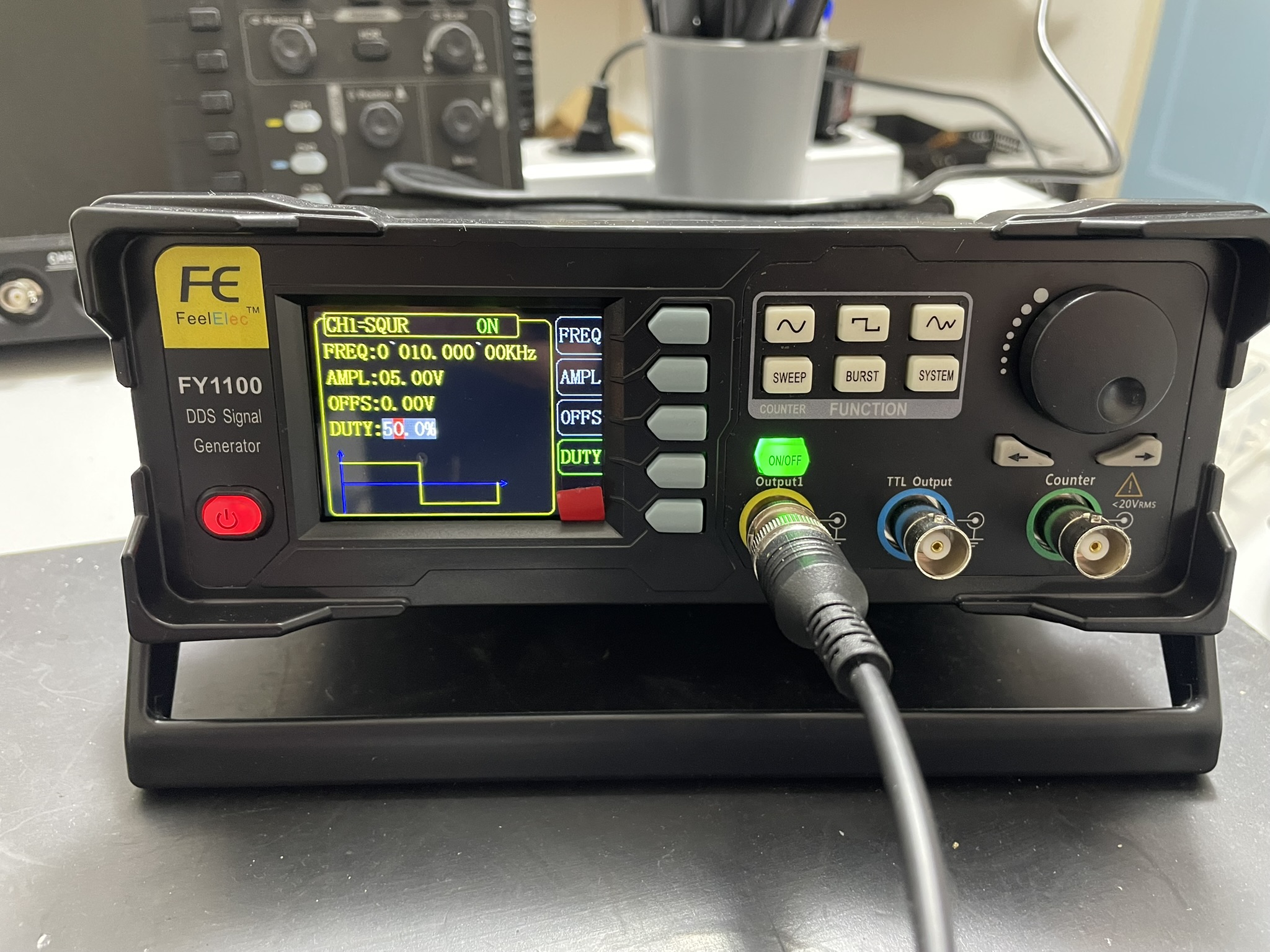 A black portable radio transceiver with LCD screen and control buttons displays text on its front panel.