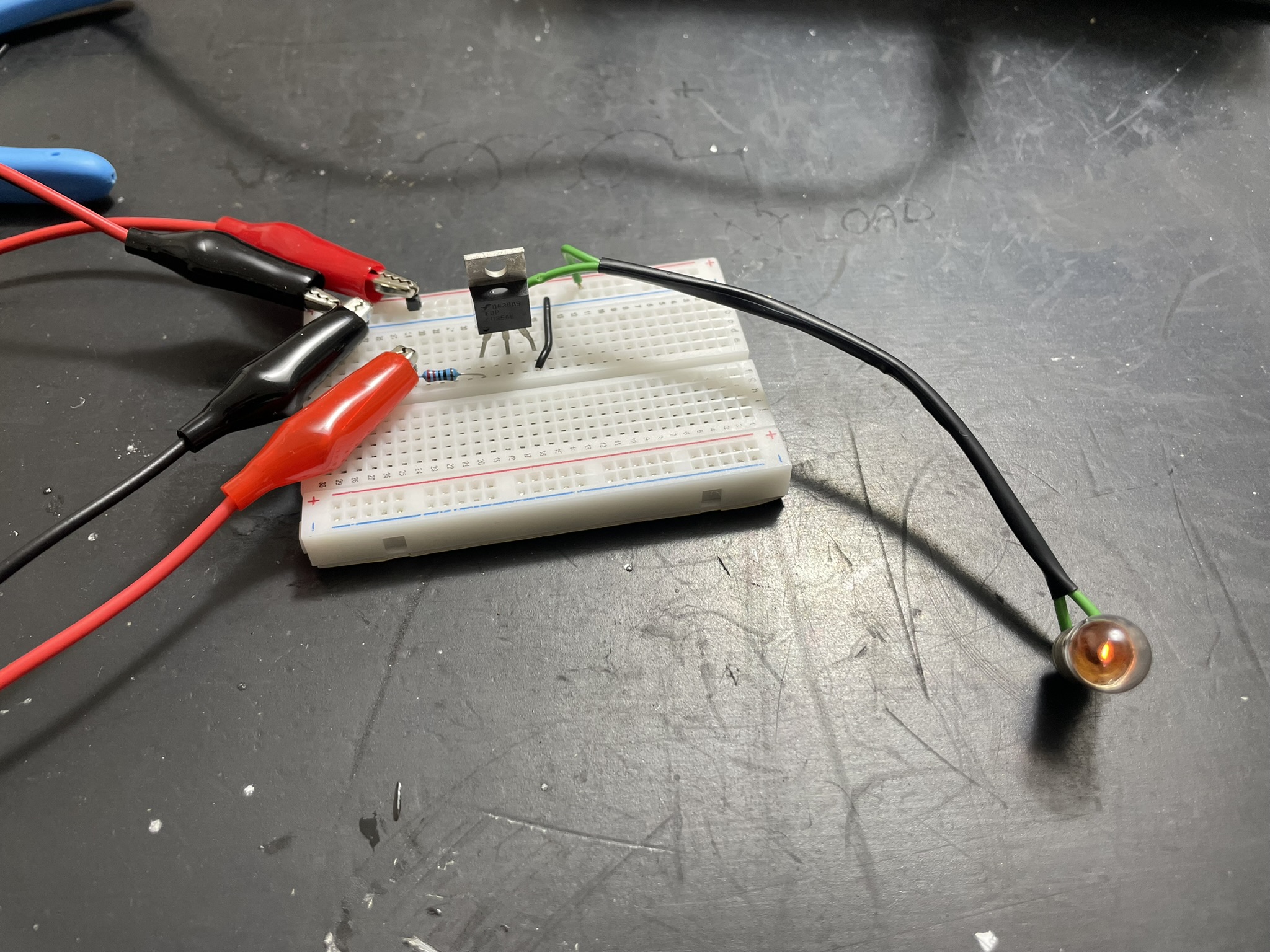 An Arduino board on a breadboard with various electronic components, including LEDs, resistors, and potentiometers.