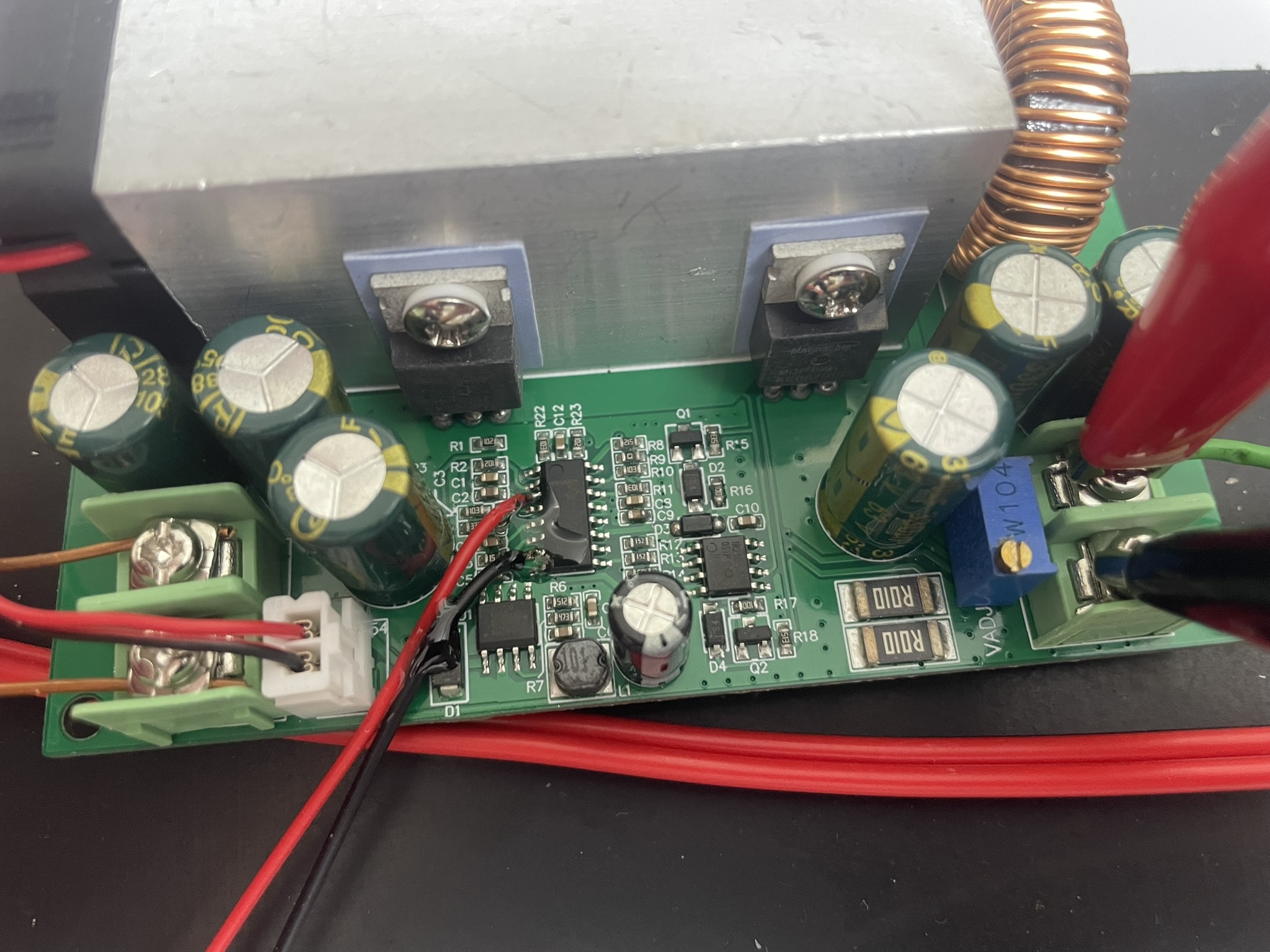 TL494 buck converter hack on AliExpress PCB with CR123A batteries, IC chip, capacitors, resistors, and alligator clips