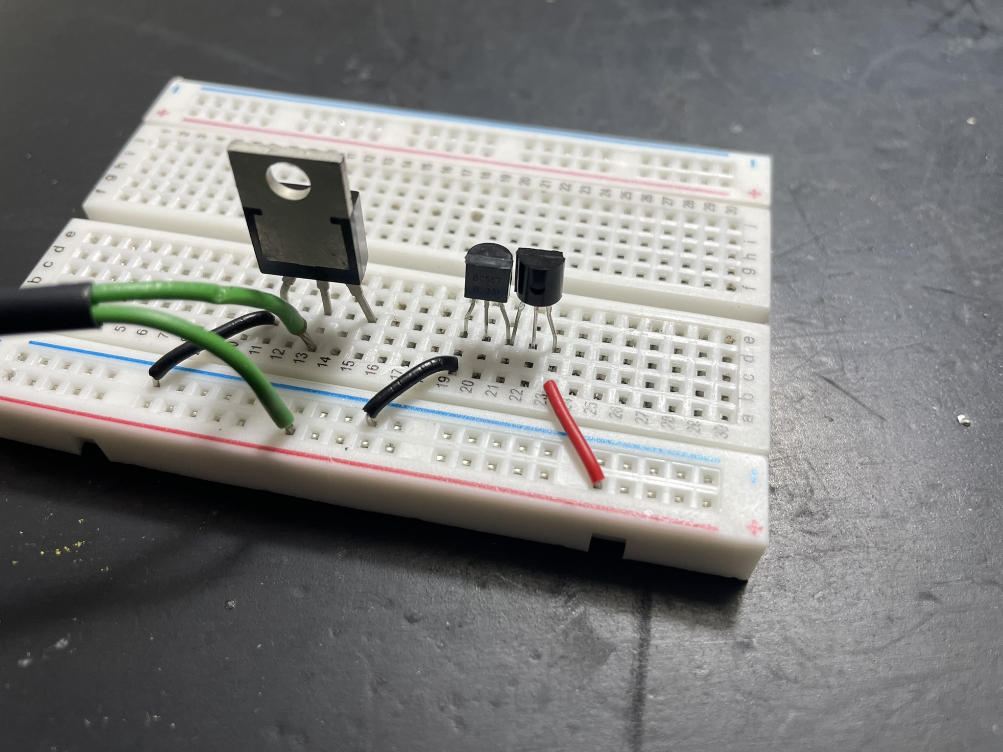 A breadboard setup with components and jumper wires, featuring an op-amp IC chip and blue resistors.