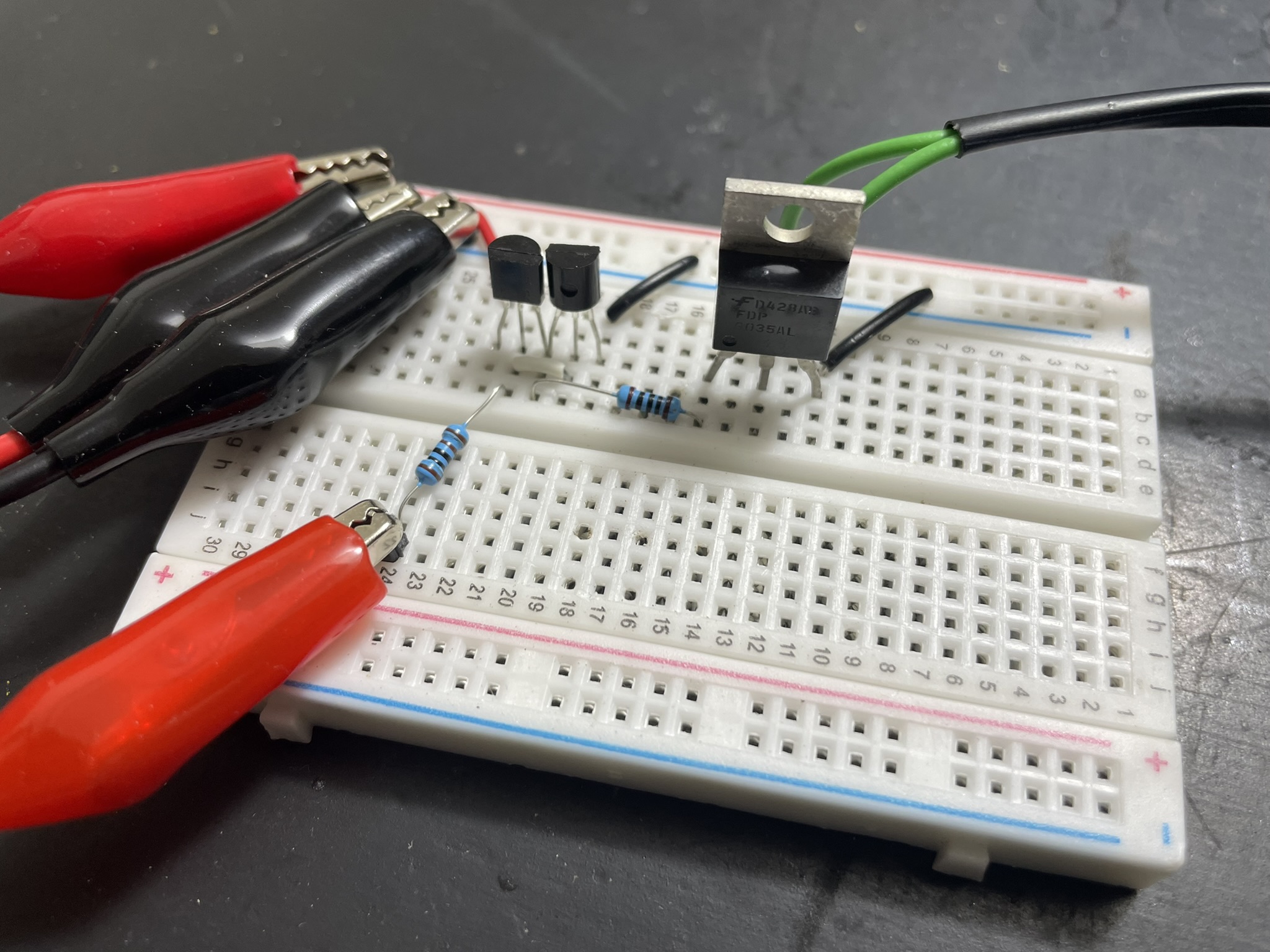 An Arduino microcontroller and various electronic components are mounted on a breadboard with resistors, diodes, and