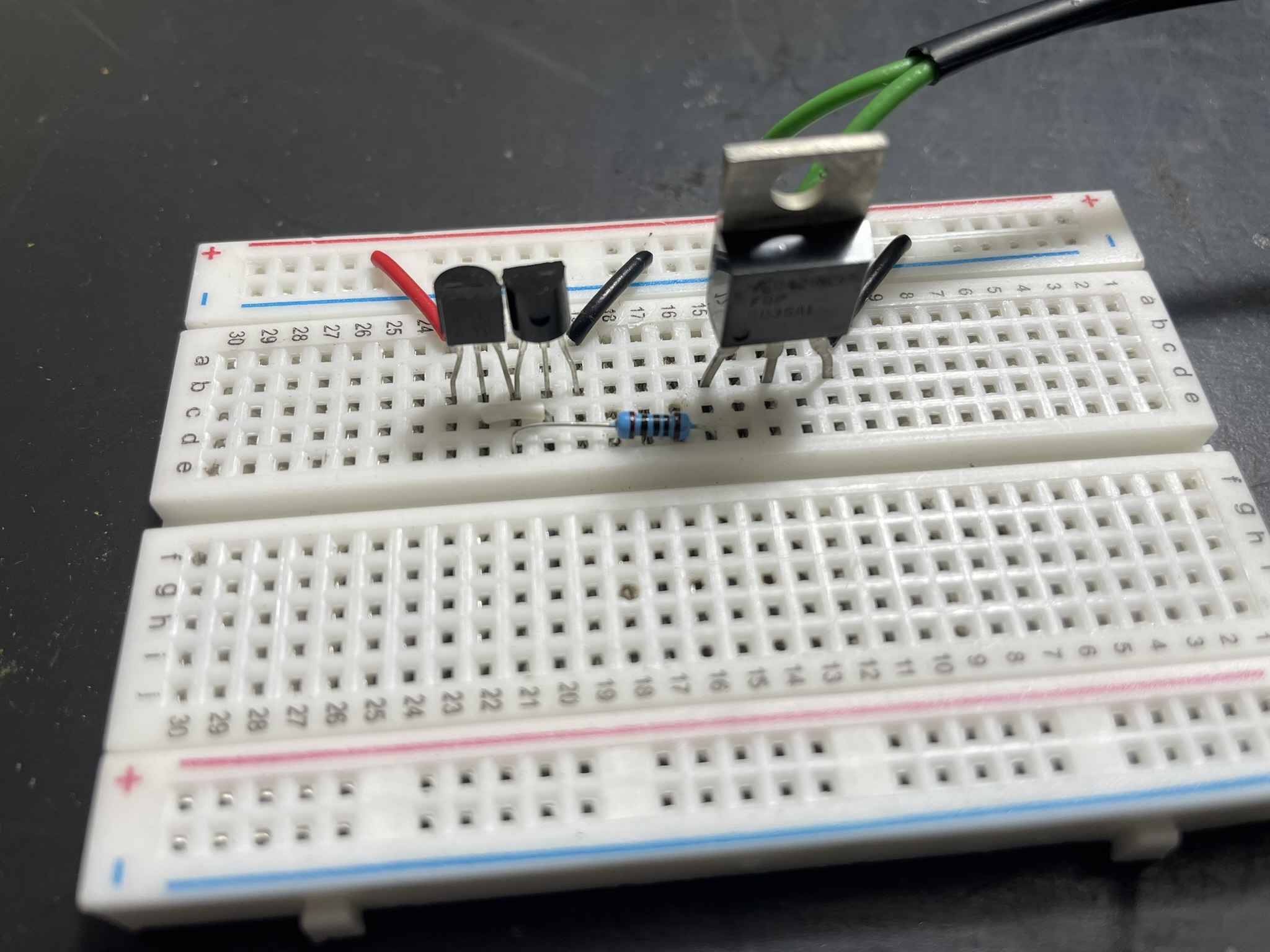 A low-value resistor on an electronic breadboard prevents ringing at a MOSFET gate when switching at high PWM