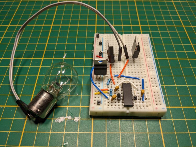 This is the IR2110 DIP package on a breadboard hooked up to some peripheral components and two MOSFETs to drive a light bulb.