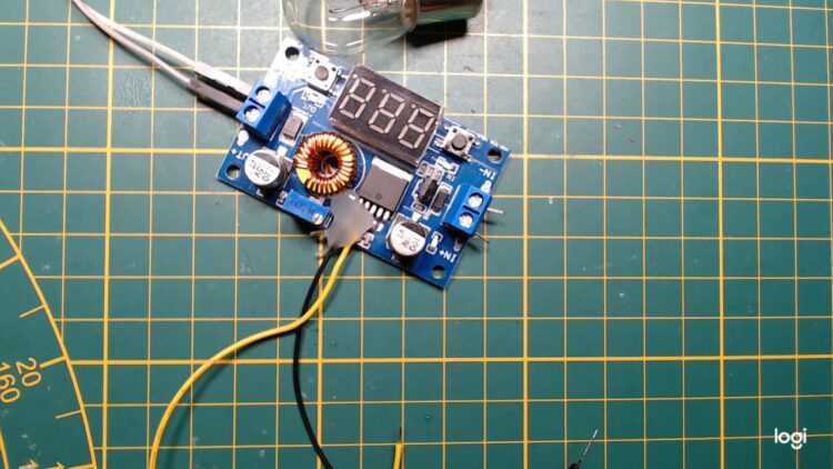 An eBay buck converter with a wire attached to the feedback pin of the controller IC
