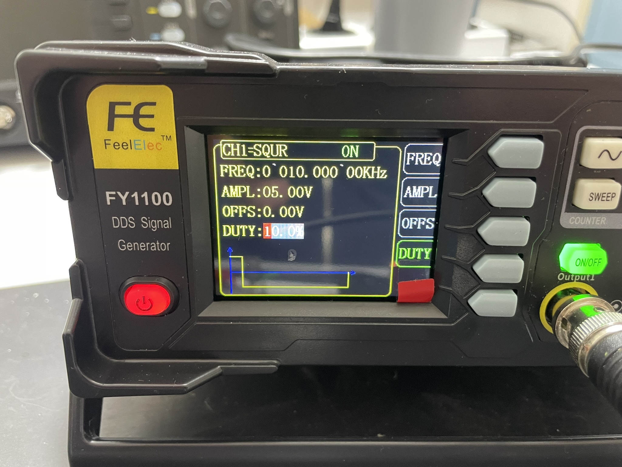 Portable radio with FEE branding and digital display for status indicators and controls