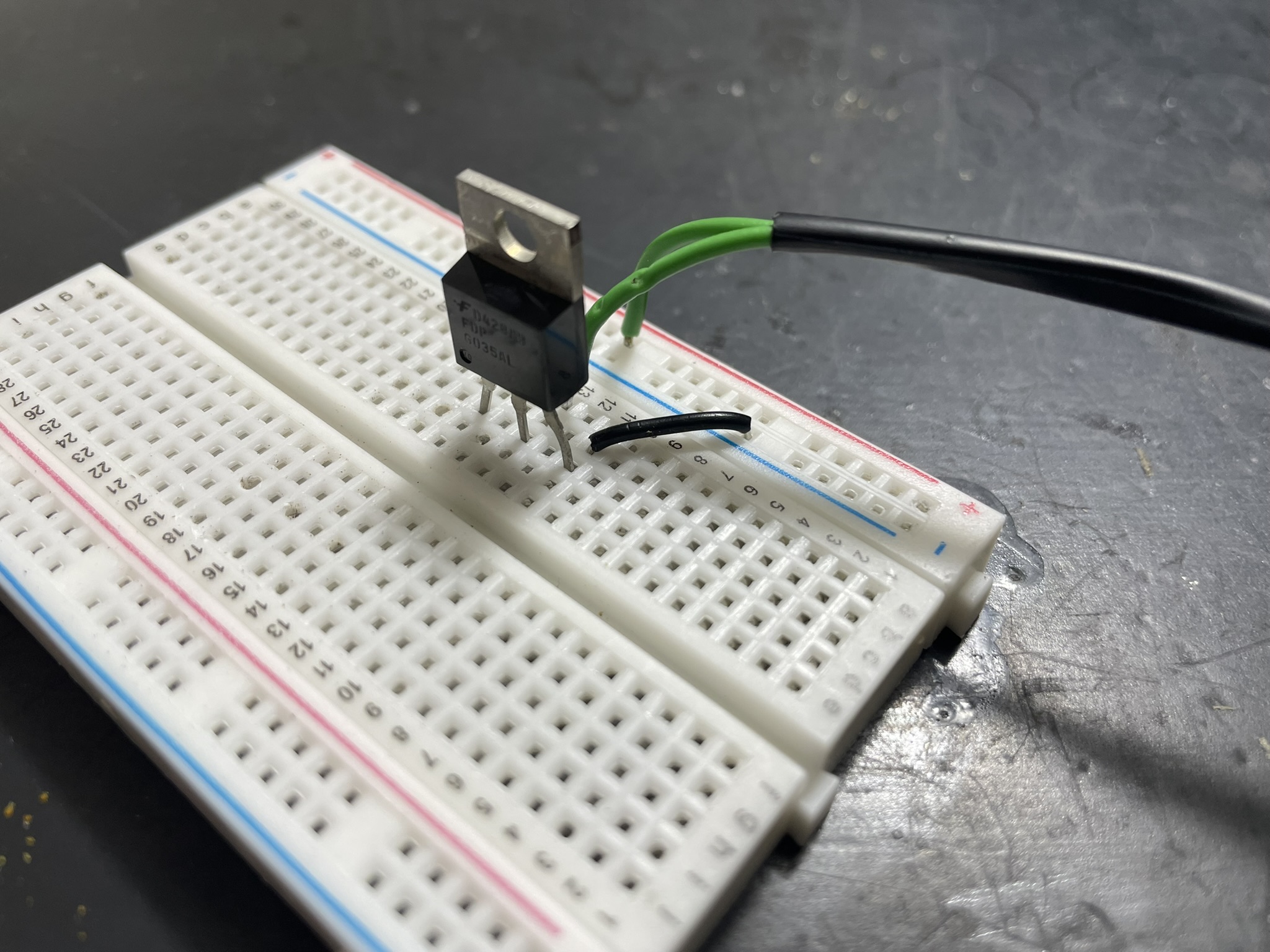 Low-side switching circuit for bicycle light using transistor to control 30A current