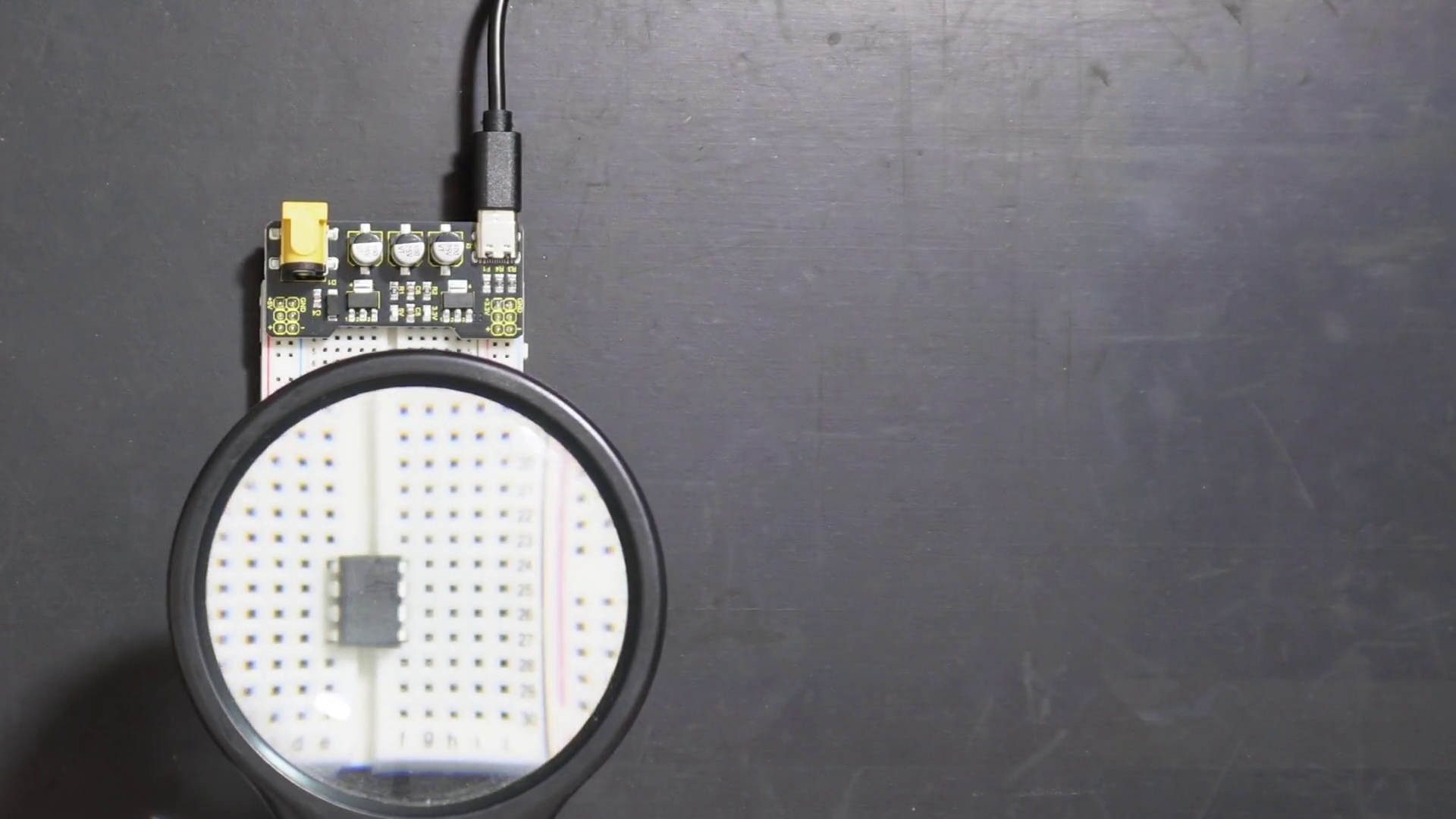 Op-Amp under a magnifying glass to read type and model.