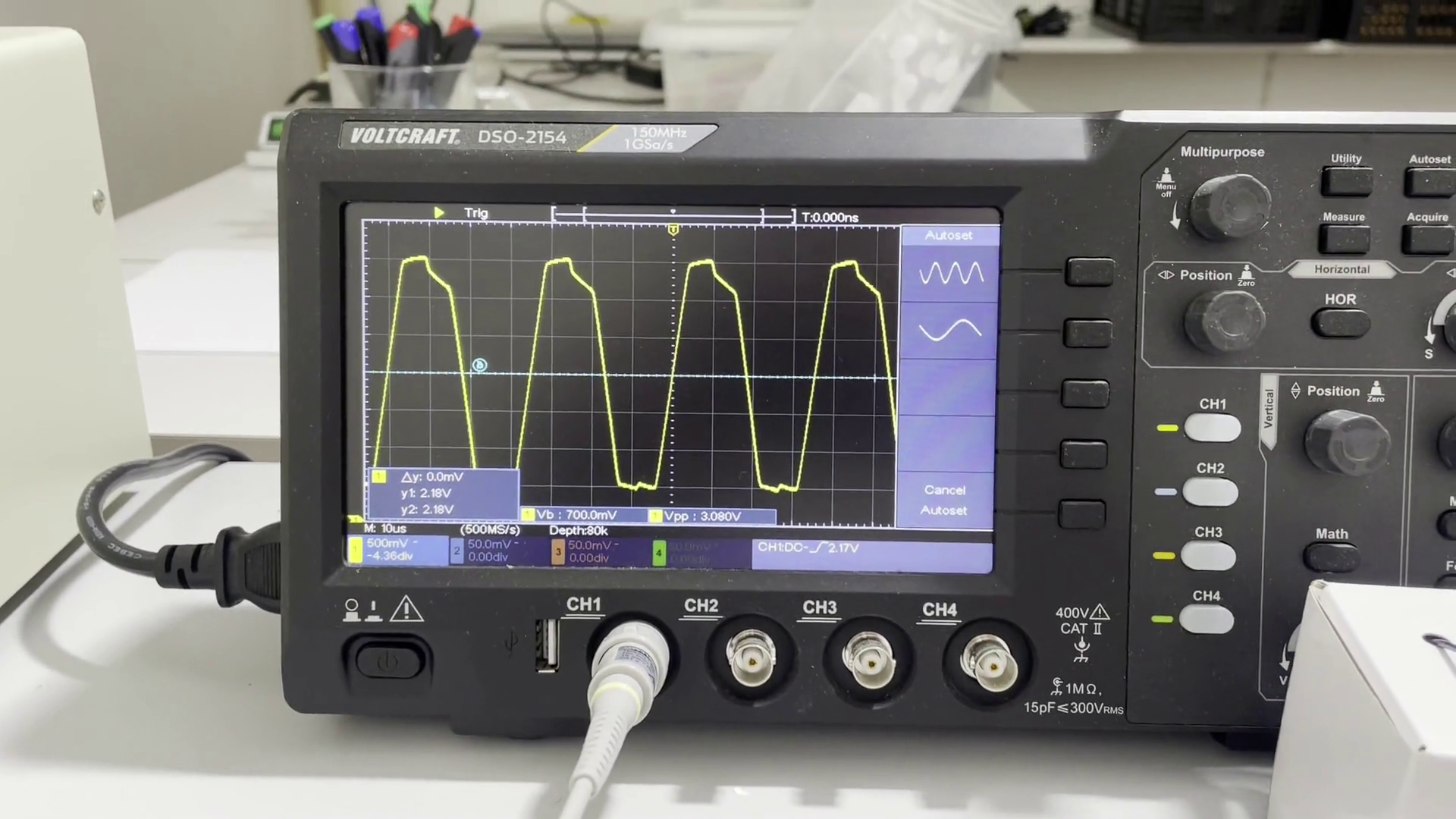 Oscilloscope shows an imperfect square wave signal coming from an oscillator circuit.