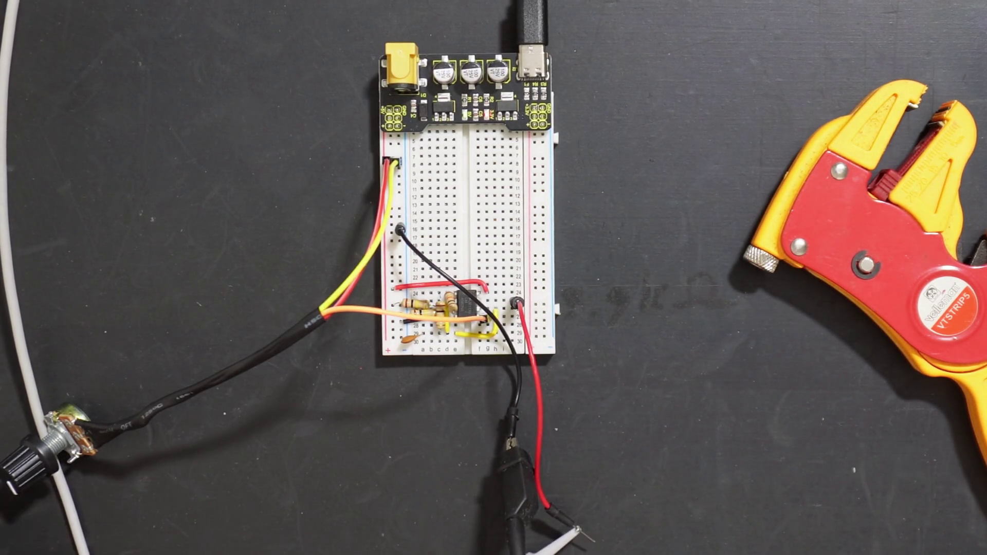 Added probe wires to variable PWM signal generator circuit on a breadboard.